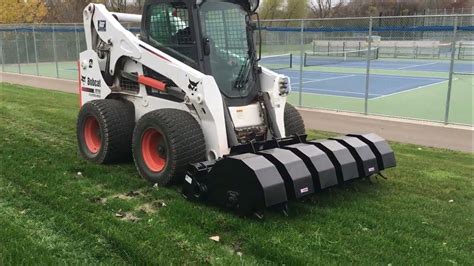 aerater attachment for skid steer|caterpillar skid steer aerator attachment.